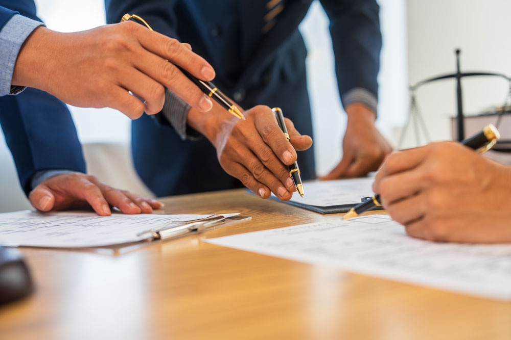 A business litigation attorney signing a contract