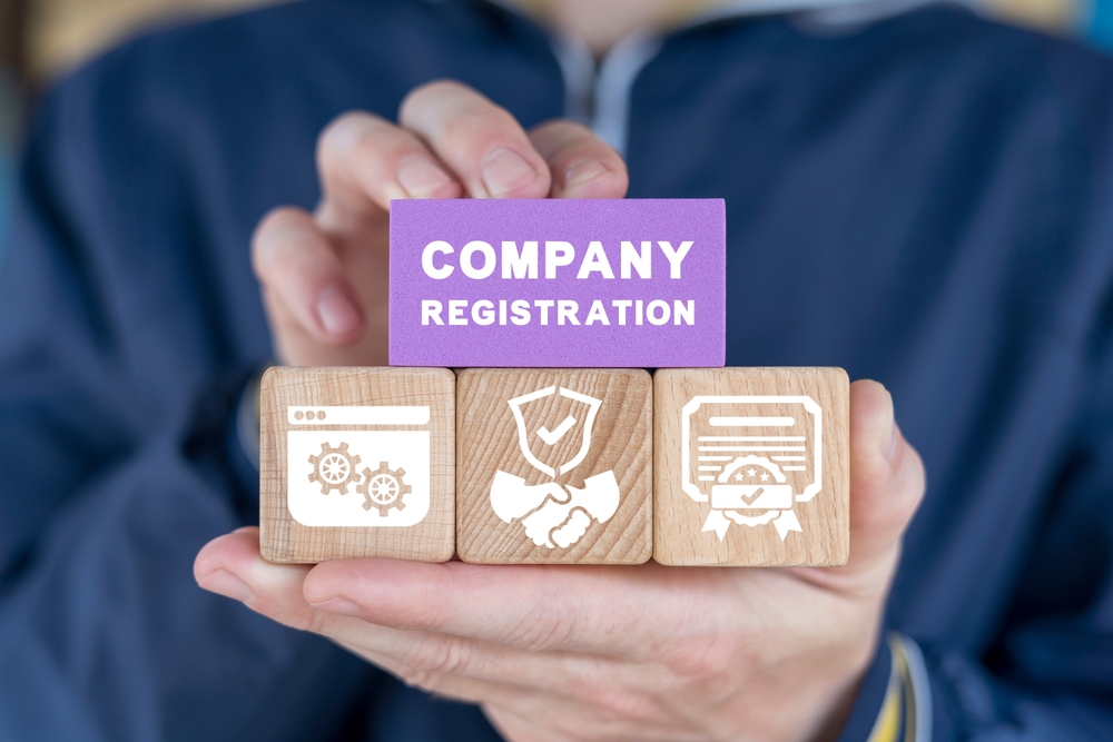 Man,Holding,Colorful,Blocks,Sees,Inscription:,Company,Registration.,Concept,Of